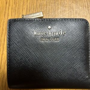 Black Kate Spade bifold wallet.
